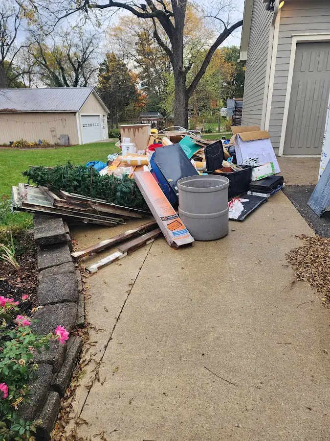 Dumpster being loaded with debris for Estate Cleanout Dumpster Rental in Cumberland